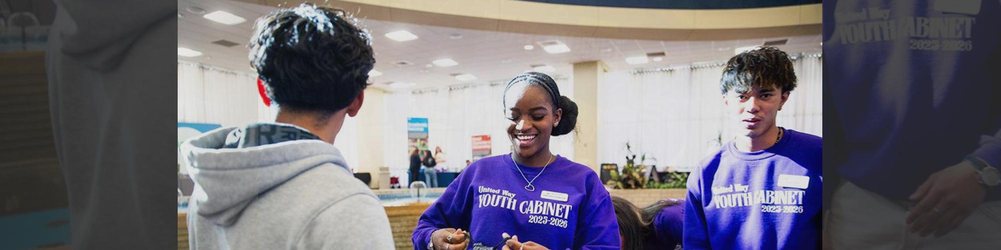 Youth volunteers handing out materials during a leadership event in Amarillo
