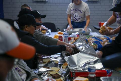 Volunteers preparing meals together at a community Day of Caring event 