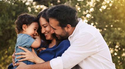 Parents holding their young child