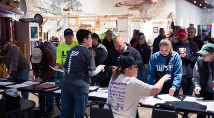 Volunteers registering at a community event in Amarillo, showing local partnerships.